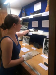Rancho Los Cerritos' volunteer curatorial intern Nevada Evers installs the latest special exhibit in the library case in commemoration of the 175th anniversary of the adobe's construction (built in 1844) and specifically the sheep ranching years (1866-1929).
