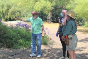 Steve points out an archeological dig site to Eileen and Marie